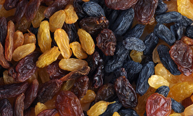 Background of raisins of various colors and sizes. Texture of different varieties of raisins.