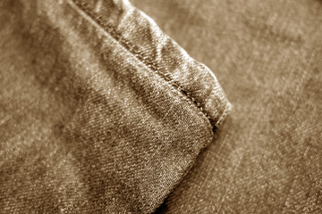 Fototapeta na wymiar Jeans denim texture with blur effect in brown tone.
