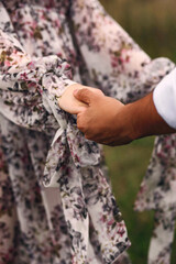 Concept of human relation, community, togetherness,  love. Close up photo of lovers holding hands each other on nature background