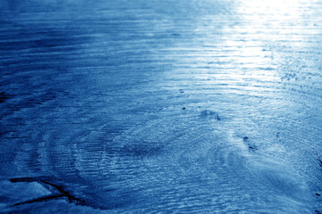 Old oak board texture as background with blur effect in navy blue tone.