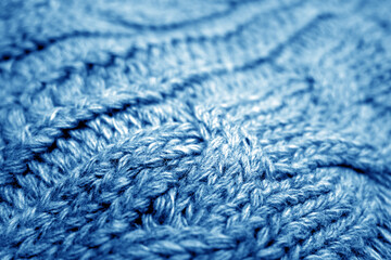 Fototapeta na wymiar Warm knitting texture with blur effect in navy blue tone.