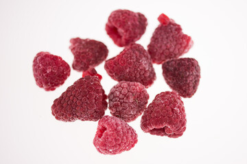 studio photo frozen raspberries on wooden plate