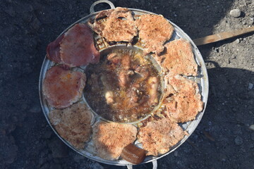 chicken legs and pork fried in oil