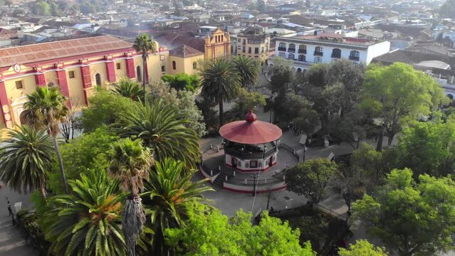 Aerial Drone flyby shot of Central Square in San Cristobal de Las Casas in the morning of sunny day