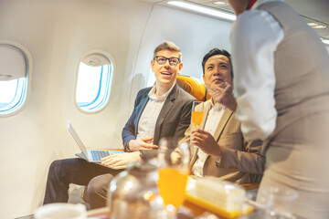 On a corporate aircraft, an air hostess serves passengers. On an airplane, a flight attendant...