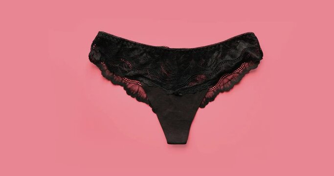 Multicolored women's underpants on a pink background. 4K stop motion animation