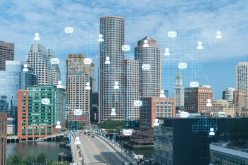 Panorama city view of Boston Harbor at day time, Massachusetts. Buildings of financial downtown. Glowing Social media icons. The concept of networking and establishing new connections between people
