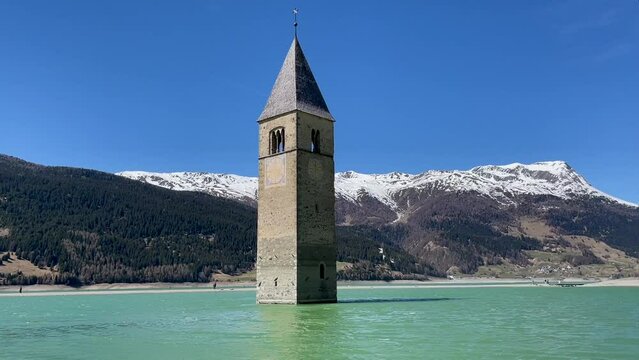The bell tower of the sunken village in the lake Resia