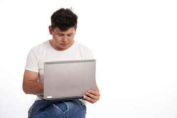 Latin man using his laptop isolated on white background