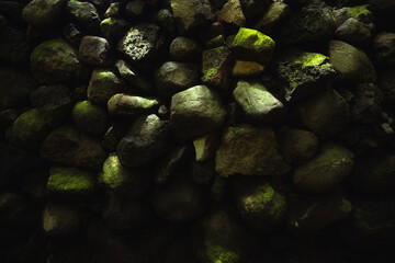 Texture of stones with moss. Stones wall background in wooded environment. Rustic textures concept to greegar your design. Stone wall texture in the forest. Amatlán, Mexico.