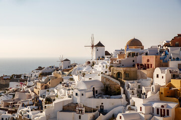 Panoramic iconic view from Oia village with Windmill on Santorini island, Greece. The place for text included.