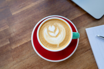 cappuccino on a wooden table top view. coffee on the table with copy space. cover for a coffee shop.
