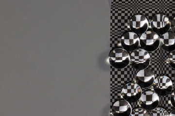 black and white modern retro background with 3d balls that reflect illusion colors, next to gray...