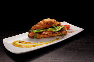 Croissant with salmon and avocado