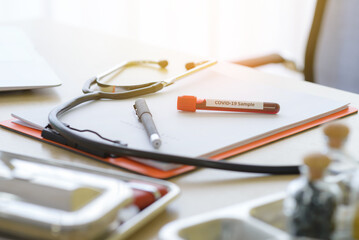 Blood samples test of Infected coronavirus or covid-19 in tube with stethoscope on table doctor.