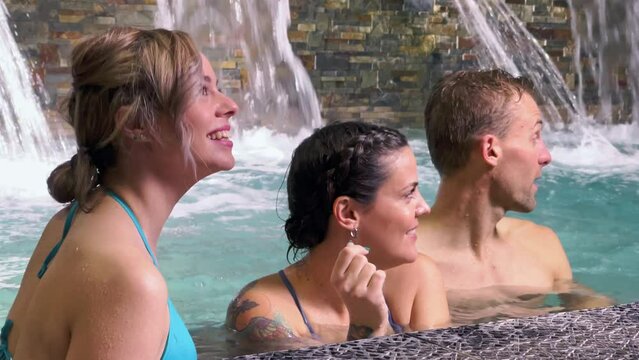 Group of 3 friends looking at somewhere else in spa pool