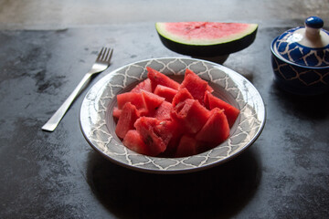 Cut fruit watermelon slices in a bowl. Close up, selective focus.
