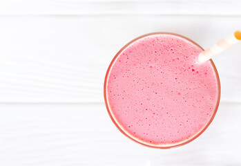Strawberry yogurt fruit juice smoothie pink colorful fruit juice milkshake blend beverage healthy high protein the taste yummy In glass drink episode morning on white wood background.