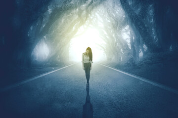 Unhappy businesswoman walking in misty forest