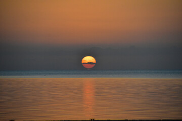 Sun going down through the clouds