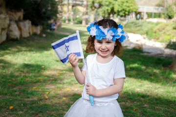 Little girl with the flag of Israel in her hands