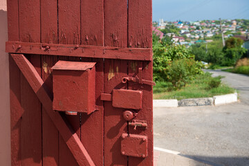 Lock and heck on a wooden door to the street in the village