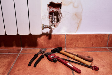 Tools of the worker sent by the homeowner's insurance company to repair the damage caused by a water leakage from the heating system in the wall of a house.