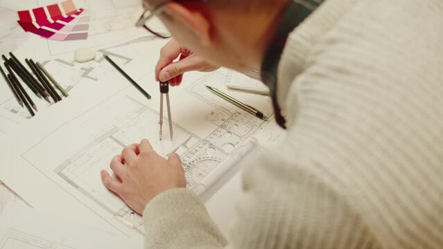 Architect designer drawing close-up. Professional engineer working, interior creator making notes in new house project, blueprint plan, drafting building.