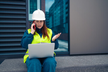 Hard working female construction engineer standing on a construction site. Confident engineer...