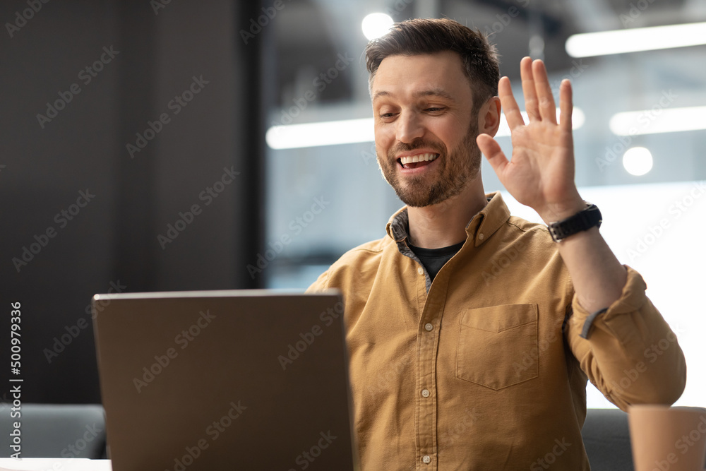 Aufkleber man waving hello to laptop making video call in office