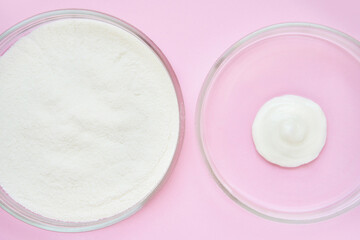 Collagen white powder. Pastel color background. Health product. Woman cosmetics concept. Sport supplement. Skincare cosmetics. Pink monochrome. Cream smear.