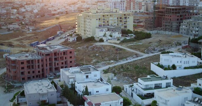 Aerial Forward Shot Of Residential Buildings On Landscape In Town During Sunset - Djerba, Tunisia