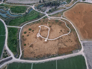 Aerial view of Tel Shukha Nahal Kibbutzim,  topped with three-storey concrete tower built in 1939 to provide protection for Kibbutz Nir David. Spring Valley Park HaMaayanot near Beit Shean