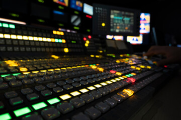 TV editor working with vision mixer in television broadcast gallery - obrazy, fototapety, plakaty