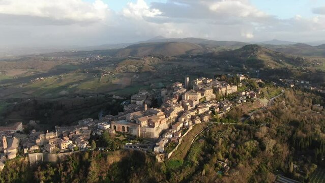 4k cinematic aerial video of golden hour at the medieval town Montepulciano in Tuscany, Italy at sunset