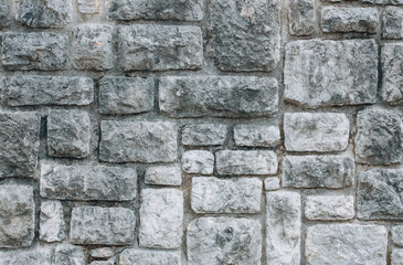 Old stone wall with gray brick