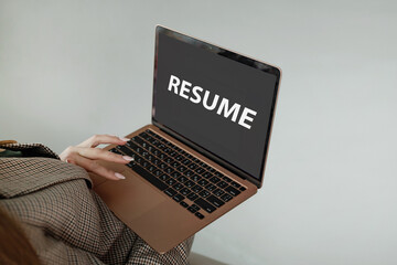 A girl looking for a job, composes and sends a resume online