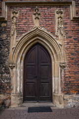 Fototapeta na wymiar Wooden gates in the side entrance to the church 