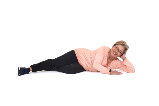 happy senior woman lying on the floor on white background