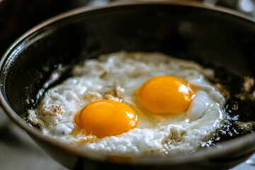 fried eggs in a frying pan