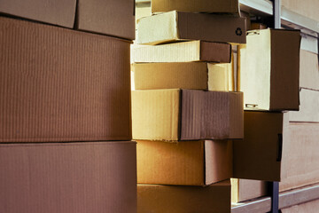 Warehouse overflowing with boxes of goods and postal parcels. Cardboard boxes on the shelves of a full stocked warehouse