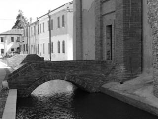 Comacchio, Italy. Del Rosario church, built in the first half of the seventeenth century. Entrance bridge to the bell tower. Black and white photo.