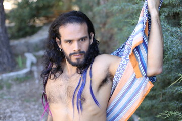 Beautiful long haired dancer showing muscular torso