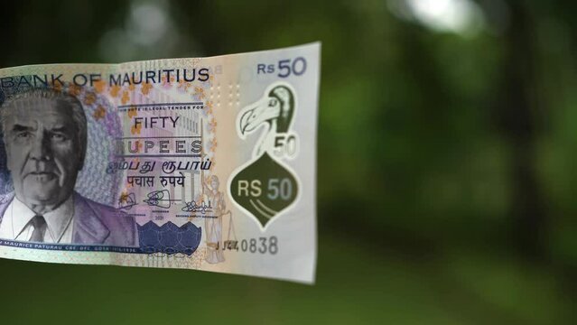 Mauritian rupee with the image of the extinct DODO bird, which is the symbol of the island of Mauritius, money in the hands