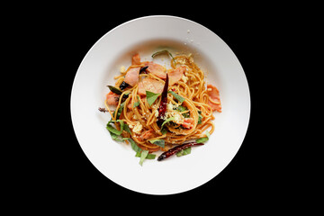 top view of homemade spicy spaghetti bacon isolated on black background