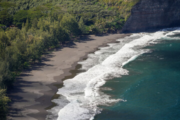 Waipi'o black sand beach on the Kohala peninsula in the north of Big Island in Hawaii, United States