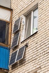 Green energy from solar panels on the wall in a multi-storey building gives free electricity to a separate apartment and save money.