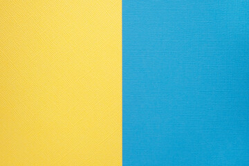 Two colored papers with a blue and yellow overlay on the floor. they divide half of the image. . High quality photo