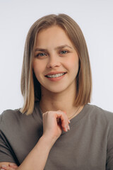 portrait of a young beautiful girl with braces, on a white background