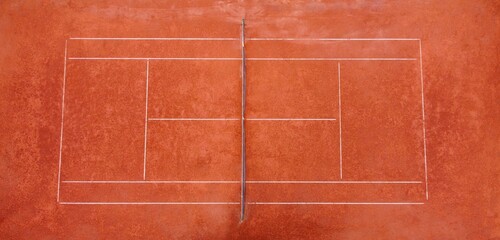 Aerial view of clay tennis courts located in a green park and used for exercise and preparation of...